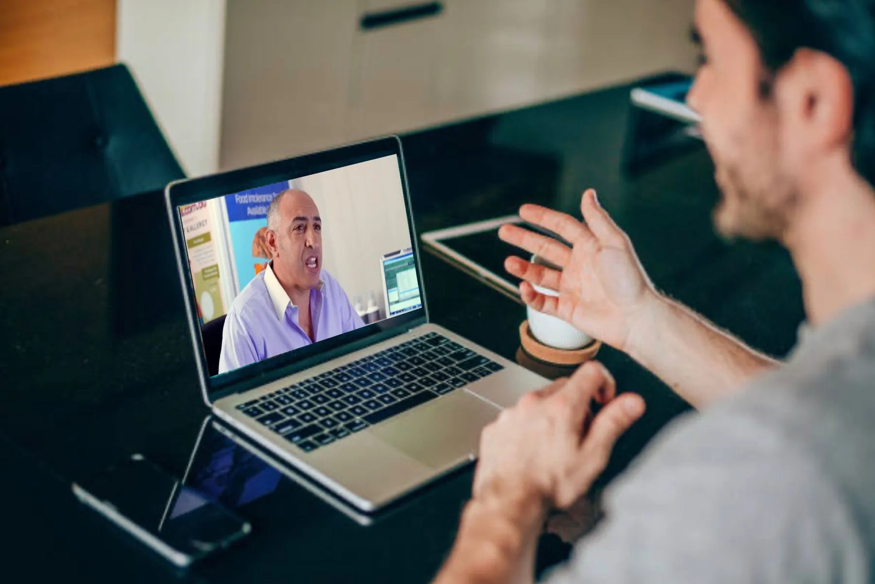 Douglas Mizzi during a warm, unhurried online consultation with a patient